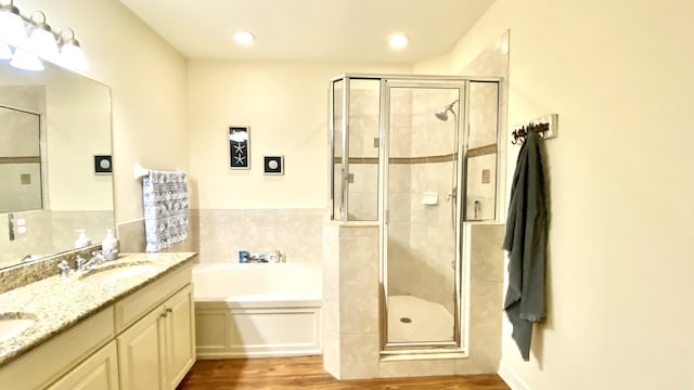 full bathroom featuring hardwood / wood-style flooring, vanity, toilet, and independent shower and bath