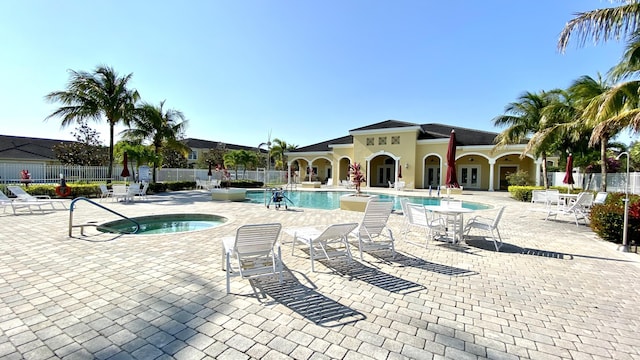 view of patio / terrace with ceiling fan and a community pool