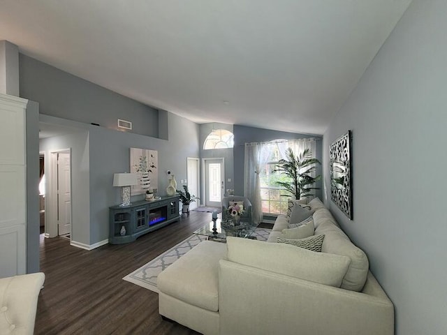 living room featuring vaulted ceiling and dark hardwood / wood-style floors