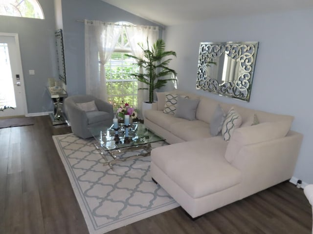 living room with lofted ceiling and dark wood-type flooring