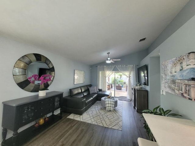 living room featuring ceiling fan, hardwood / wood-style flooring, and vaulted ceiling