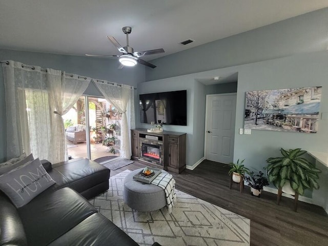 living room featuring ceiling fan and hardwood / wood-style flooring