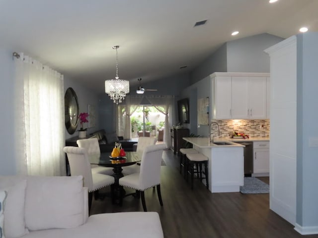 dining area featuring lofted ceiling, dark wood-type flooring, ceiling fan, and sink