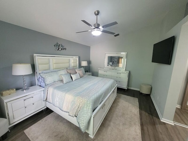 bedroom featuring ceiling fan, lofted ceiling, and dark hardwood / wood-style floors