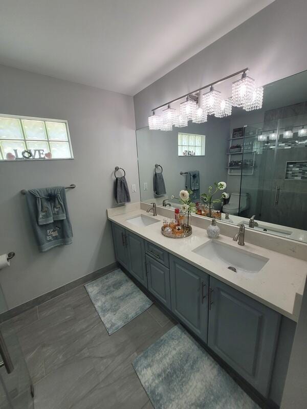 bathroom with walk in shower and vanity