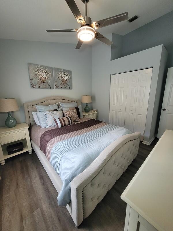 bedroom with lofted ceiling, dark hardwood / wood-style flooring, ceiling fan, and a closet