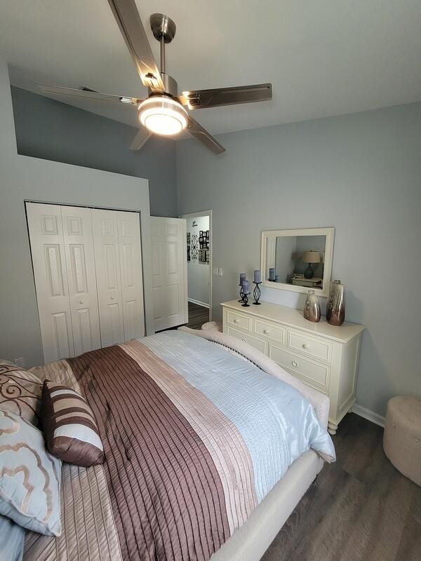 bedroom with ceiling fan, a closet, and dark hardwood / wood-style flooring