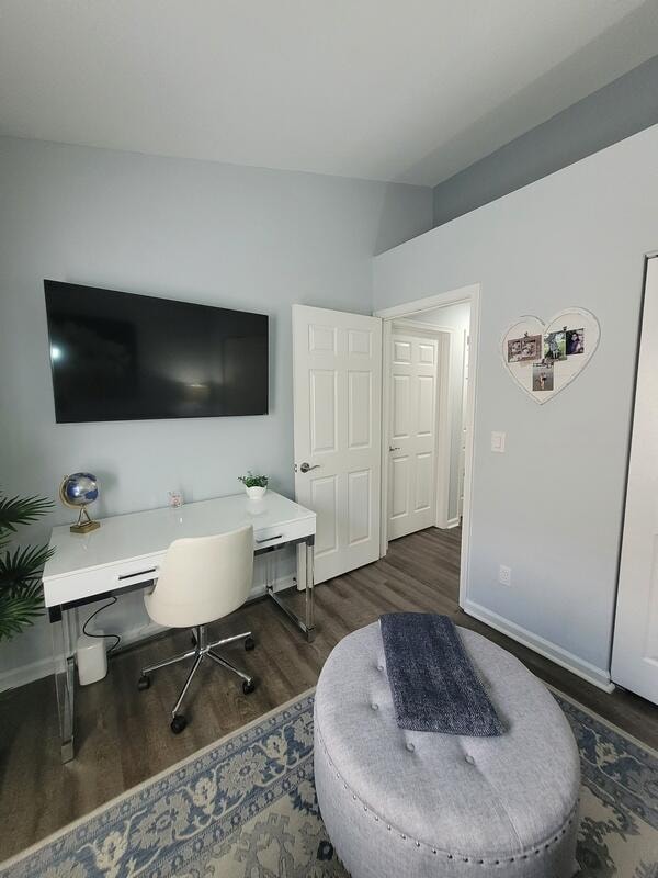 home office with lofted ceiling and dark hardwood / wood-style floors