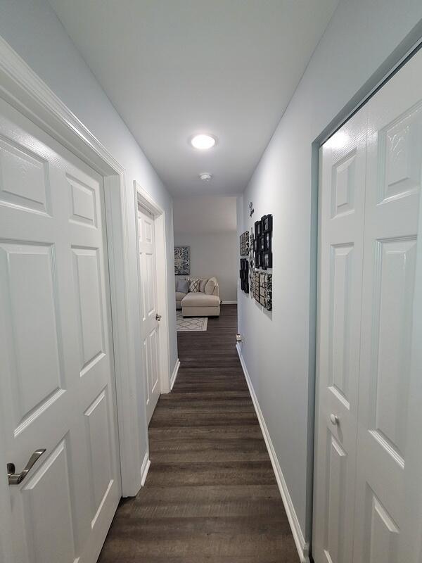 hallway featuring dark hardwood / wood-style flooring