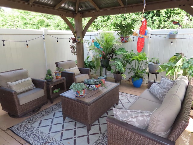 view of patio with an outdoor living space and a gazebo