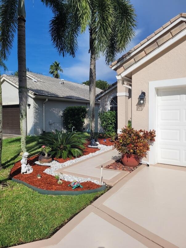 view of side of home featuring a lawn and a garage