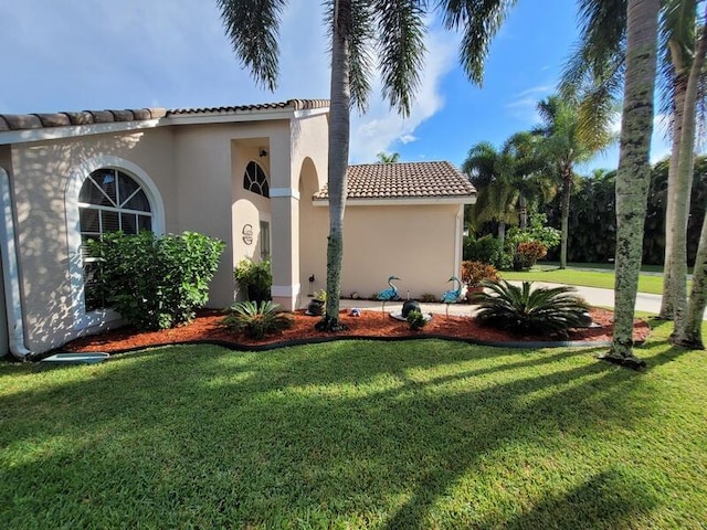 view of side of property with a lawn