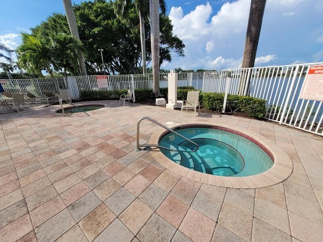 view of pool with a patio area and a community hot tub