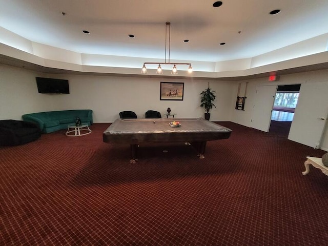 recreation room with a tray ceiling and carpet floors