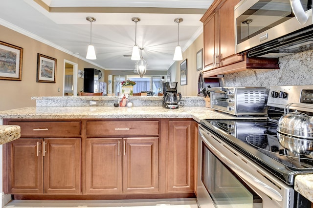 kitchen with light stone countertops, backsplash, stainless steel appliances, crown molding, and hanging light fixtures