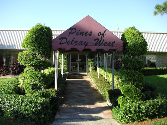 2721 SW 15th St Unit 203, Delray Beach, FL 33445 - view of building exterior featuring a carport