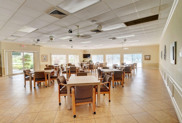 dining room featuring a paneled ceiling, ceiling fan, and light tile patterned floors