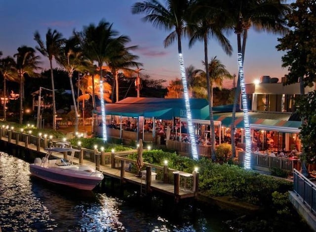 surrounding community with a boat dock and a water view