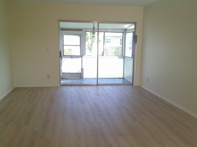 unfurnished room with light hardwood / wood-style floors