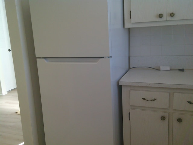 interior space with white refrigerator and light wood-type flooring