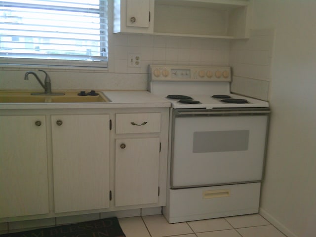 kitchen with white cabinetry, white electric range oven, light tile patterned floors, and sink