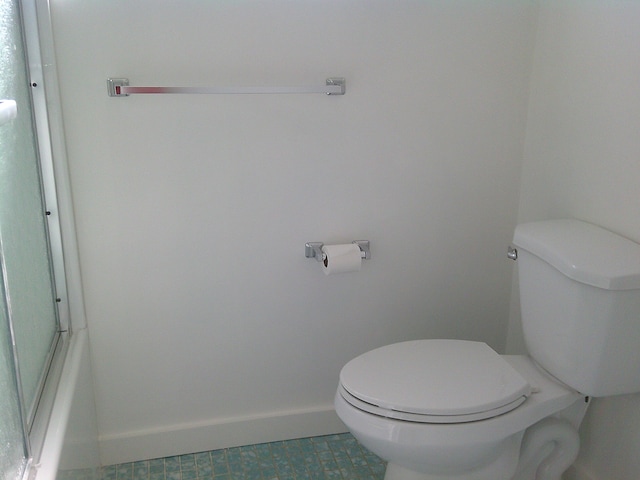 bathroom featuring toilet and tile patterned floors