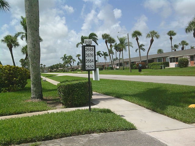 view of property's community with a lawn