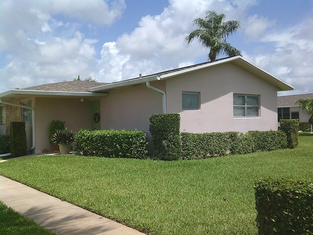 view of property exterior with a yard