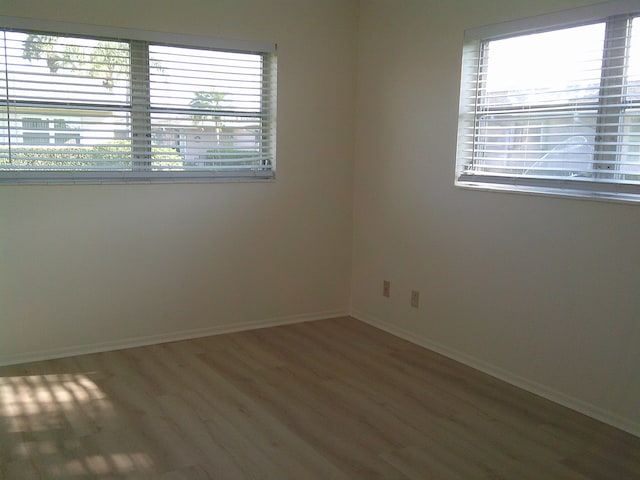 empty room featuring hardwood / wood-style flooring and a wealth of natural light