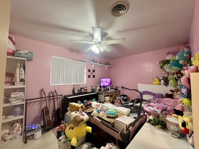 tiled bedroom with ceiling fan