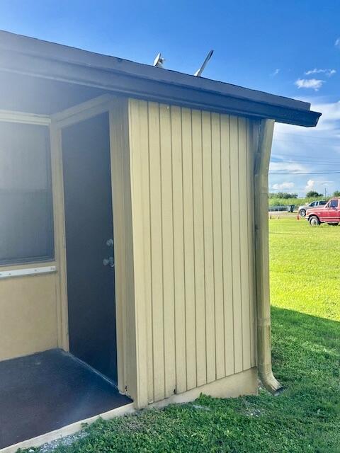 view of outbuilding featuring a yard