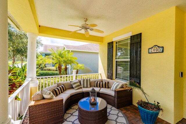 view of patio with an outdoor living space, ceiling fan, and a porch