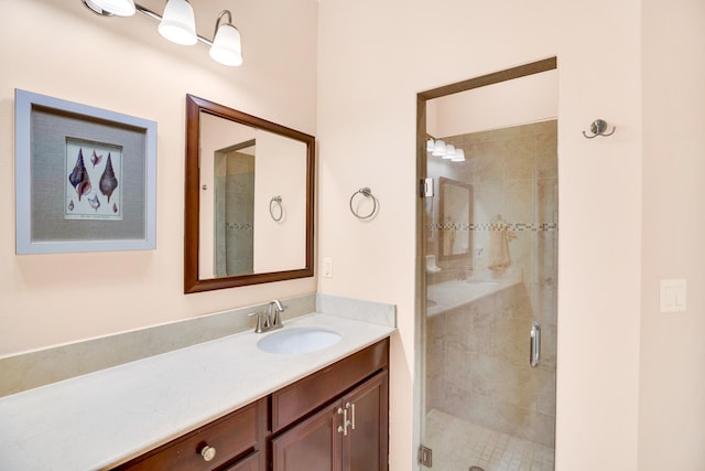 bathroom featuring walk in shower and vanity