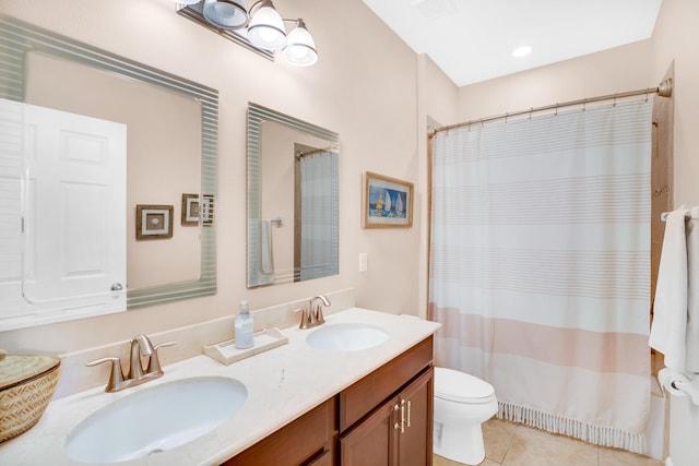 bathroom with walk in shower, vanity, toilet, and tile patterned floors