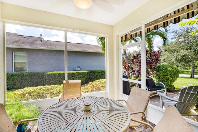 sunroom / solarium featuring ceiling fan