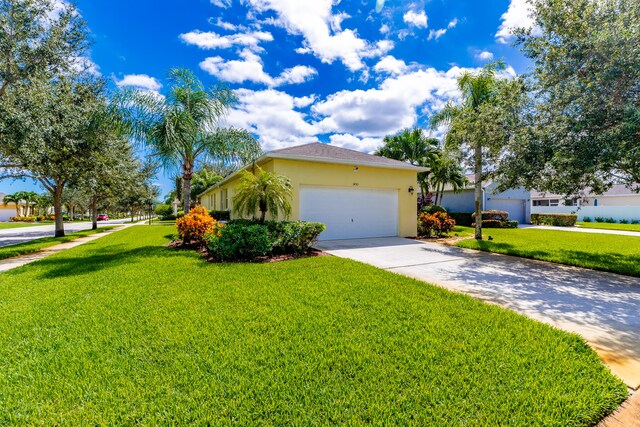 view of front of property featuring a garage and a front lawn