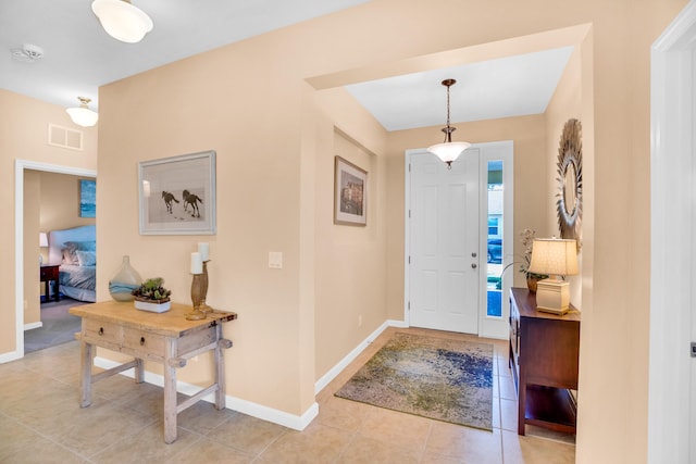 entryway with light tile patterned floors