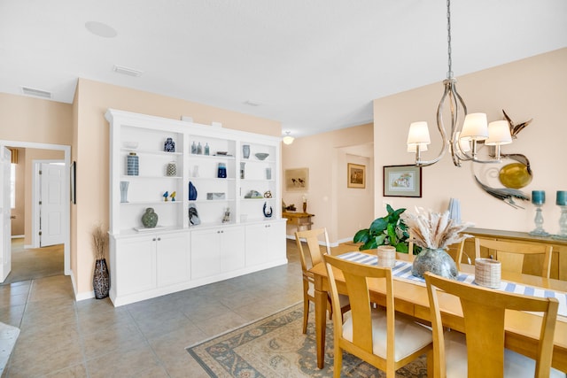 tiled dining area featuring a chandelier