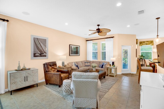 tiled living room with ceiling fan