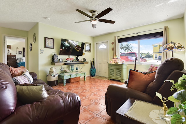 living room featuring ceiling fan, a textured ceiling, and light tile patterned flooring