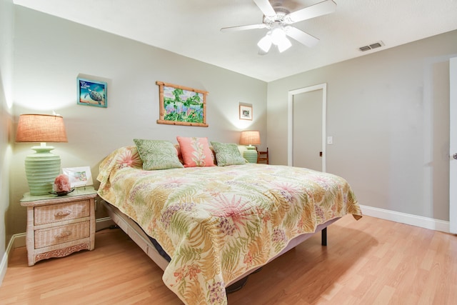 bedroom with ceiling fan and light hardwood / wood-style floors