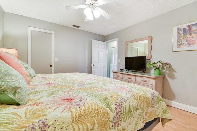 bedroom with ceiling fan and wood-type flooring