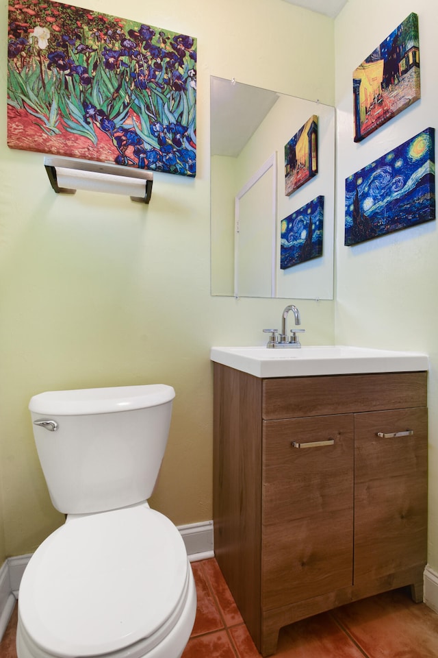 bathroom with vanity, toilet, and tile patterned floors