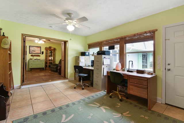 tiled office space featuring ceiling fan and a textured ceiling