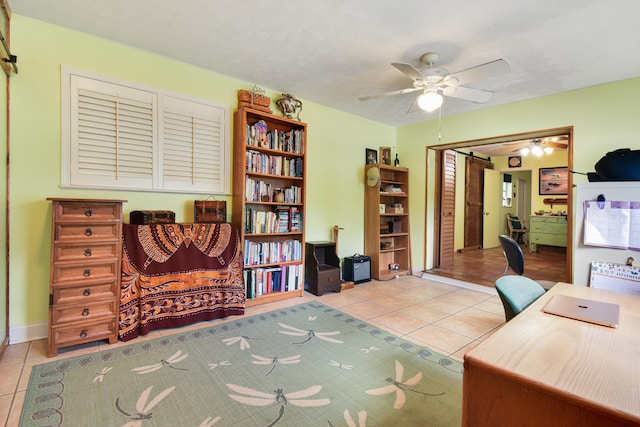 tiled office featuring ceiling fan