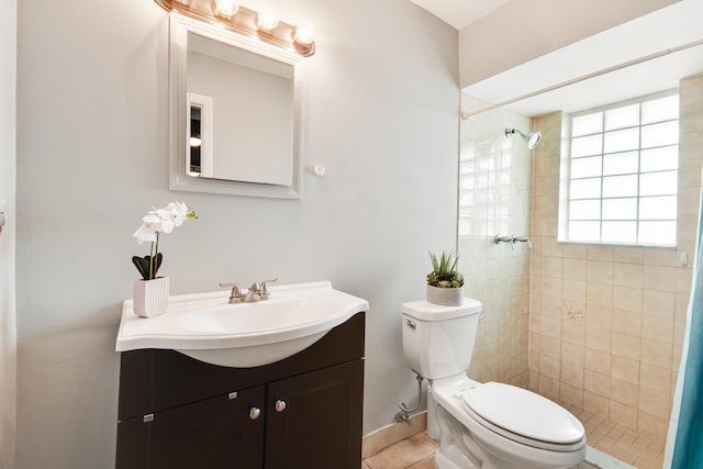 bathroom with tile patterned floors, a shower with curtain, vanity, and toilet