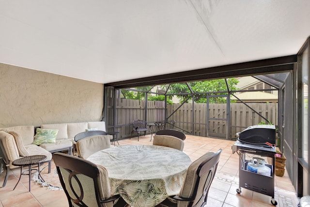 view of patio with glass enclosure and area for grilling