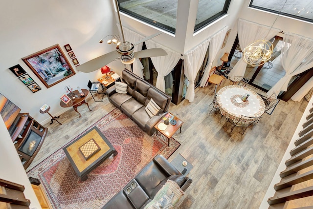 living room featuring a high ceiling, plenty of natural light, and hardwood / wood-style flooring