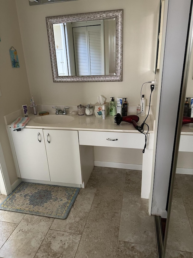 bathroom with baseboards and vanity
