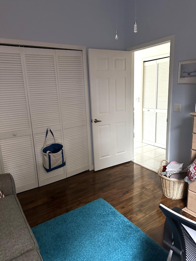 bedroom featuring dark wood finished floors and a closet